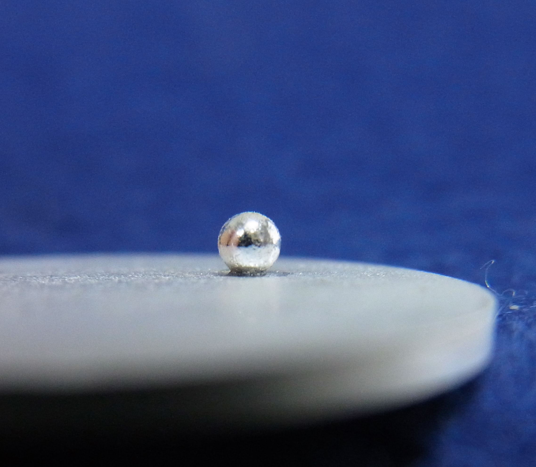 Silver granules joined to a silver plate (viewed from side)
