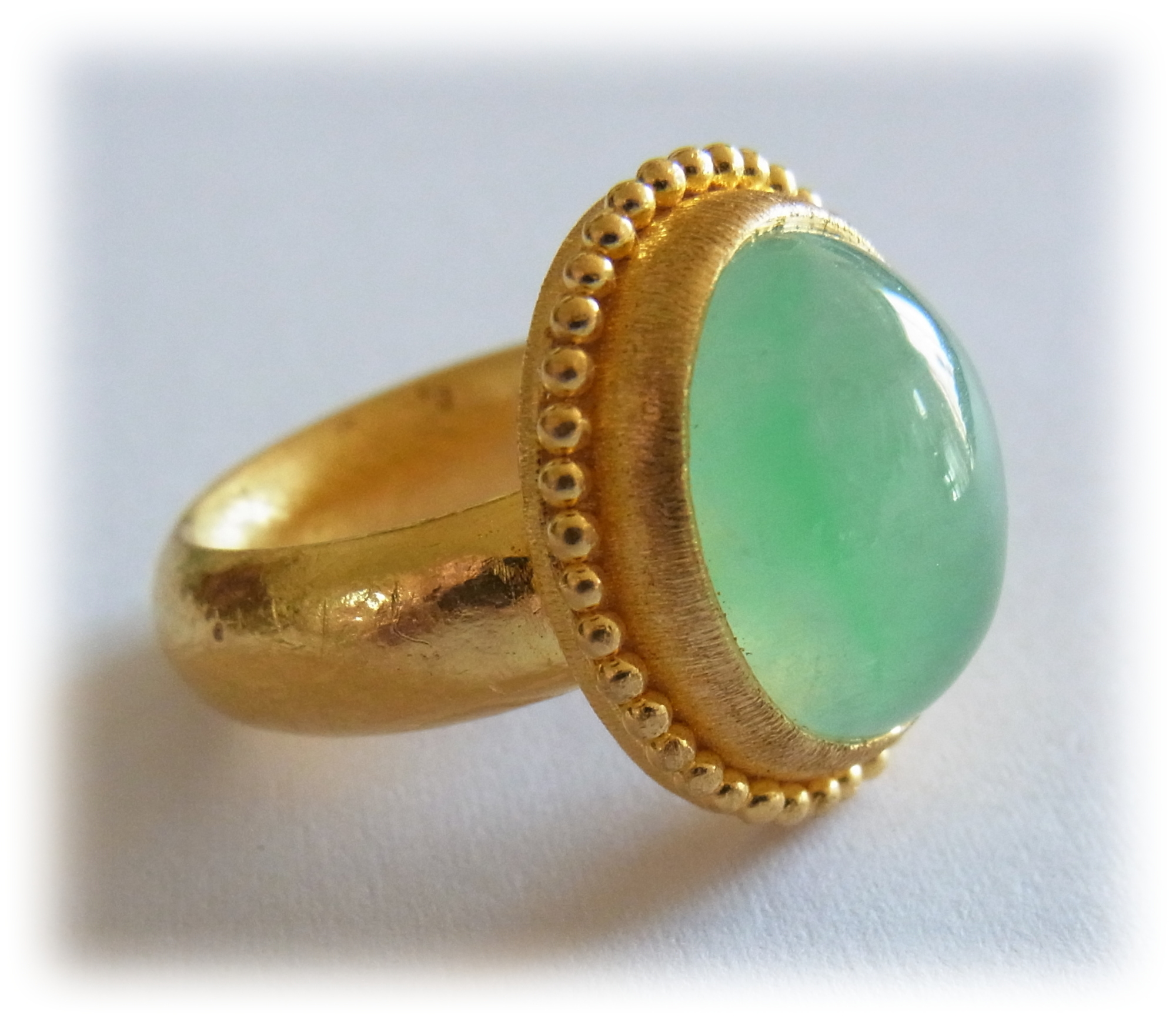 Gold ring is welded with 1.2mm diameter gold granules around the bezel.